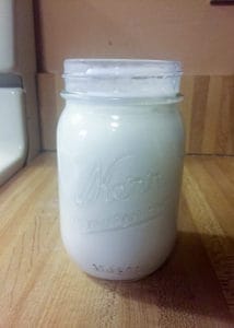 pour cream into a jar with buttermilk 